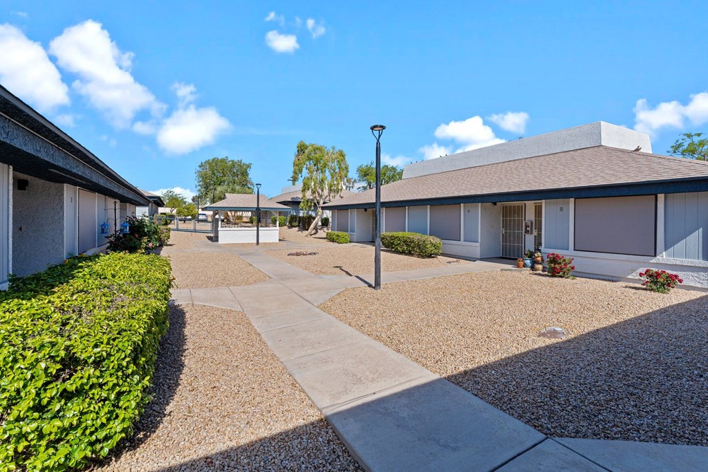 A sunny day at a residential area with houses and a clear blue sky.