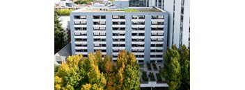 an aerial view of a building surrounded by trees