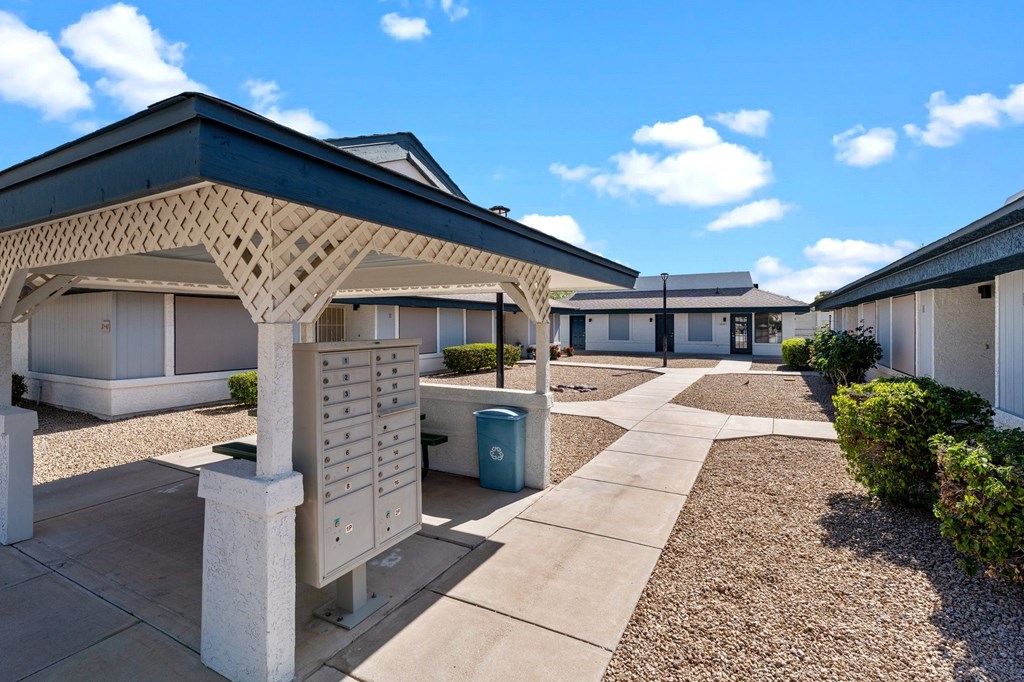 A sunny day at a residential complex with a clear blue sky.