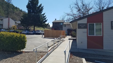 a sidewalk in front of a building with a ramp next to it
