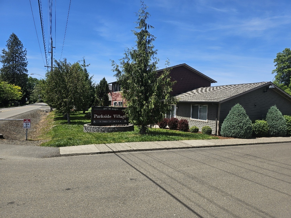 A sign in front of a house reads "Parkside Villas".