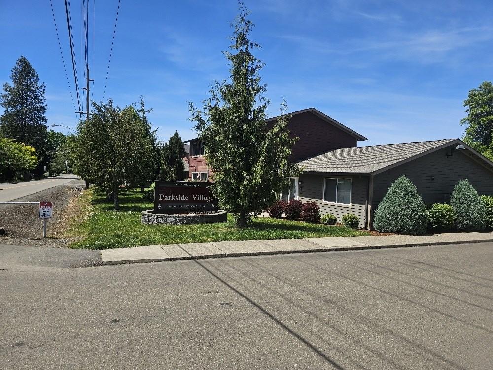 A sign in front of a house reads "Parkside Villas".