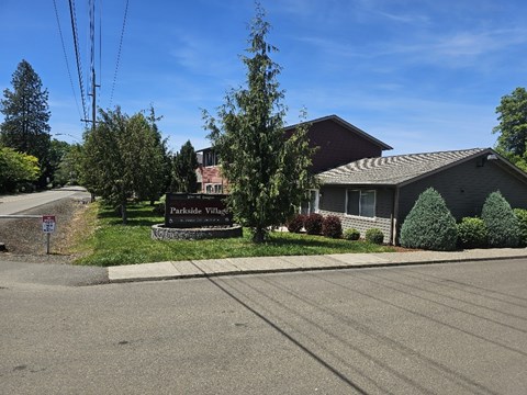A sign in front of a house reads "Parkside Villas".