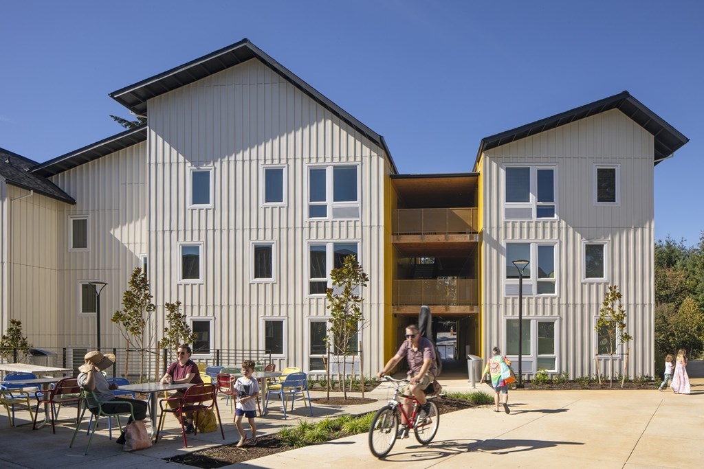 A modern building with a bicycle parked in front.