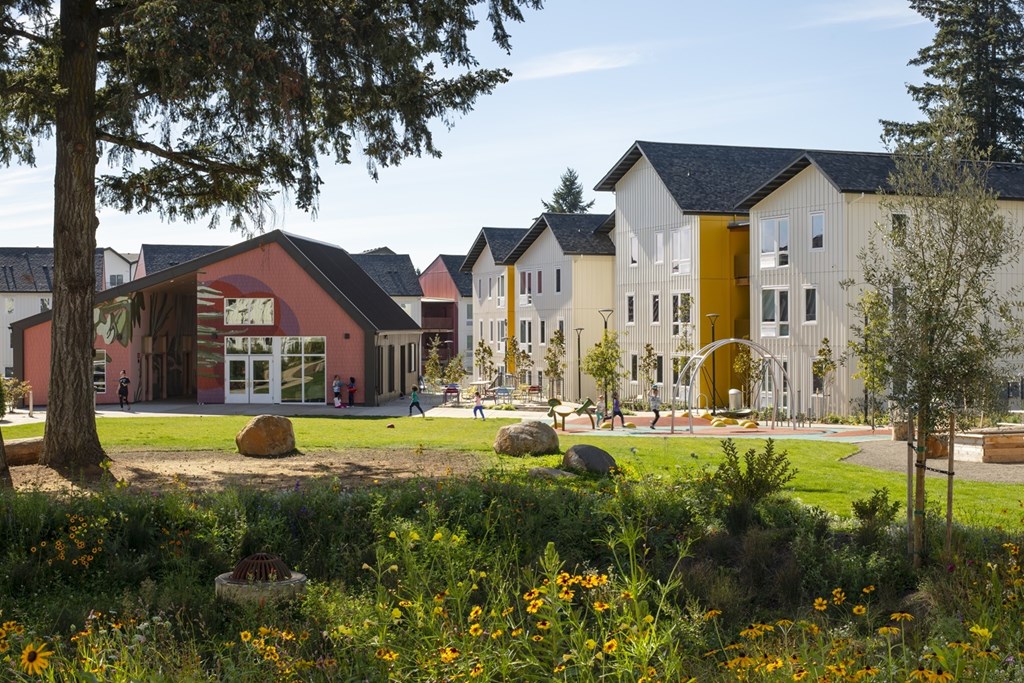 A field of flowers in front of a building.
