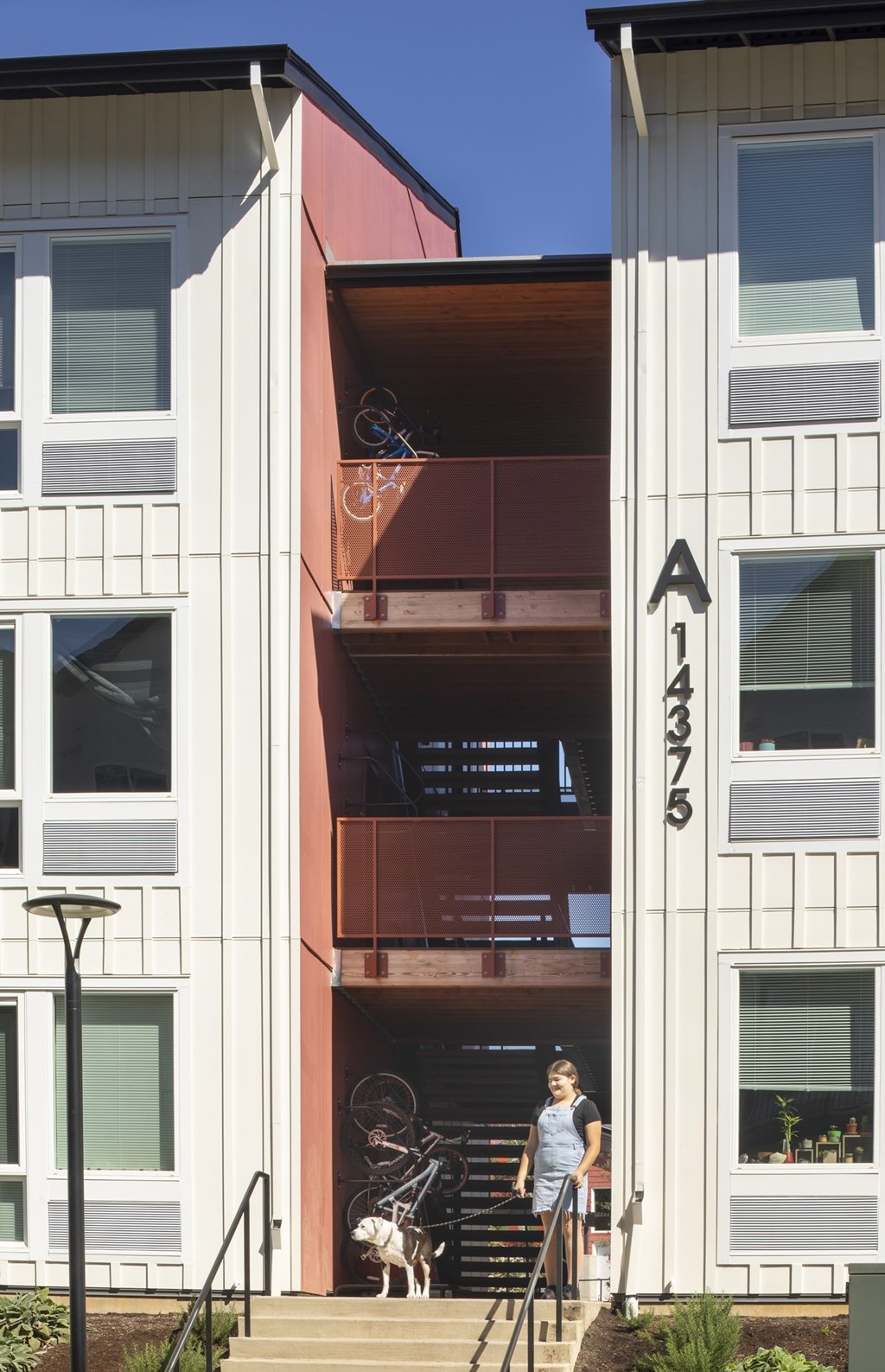 A woman is standing on the stairs of apartment A375.