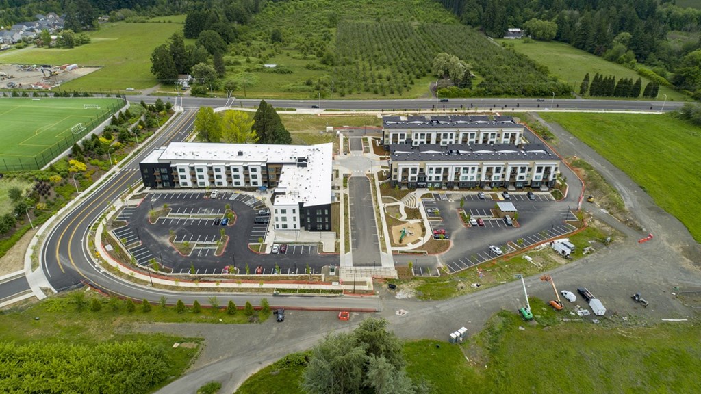 A large building with a parking lot in front of it.