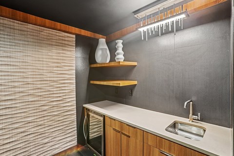 A modern kitchen with a wooden cabinet and a white countertop.