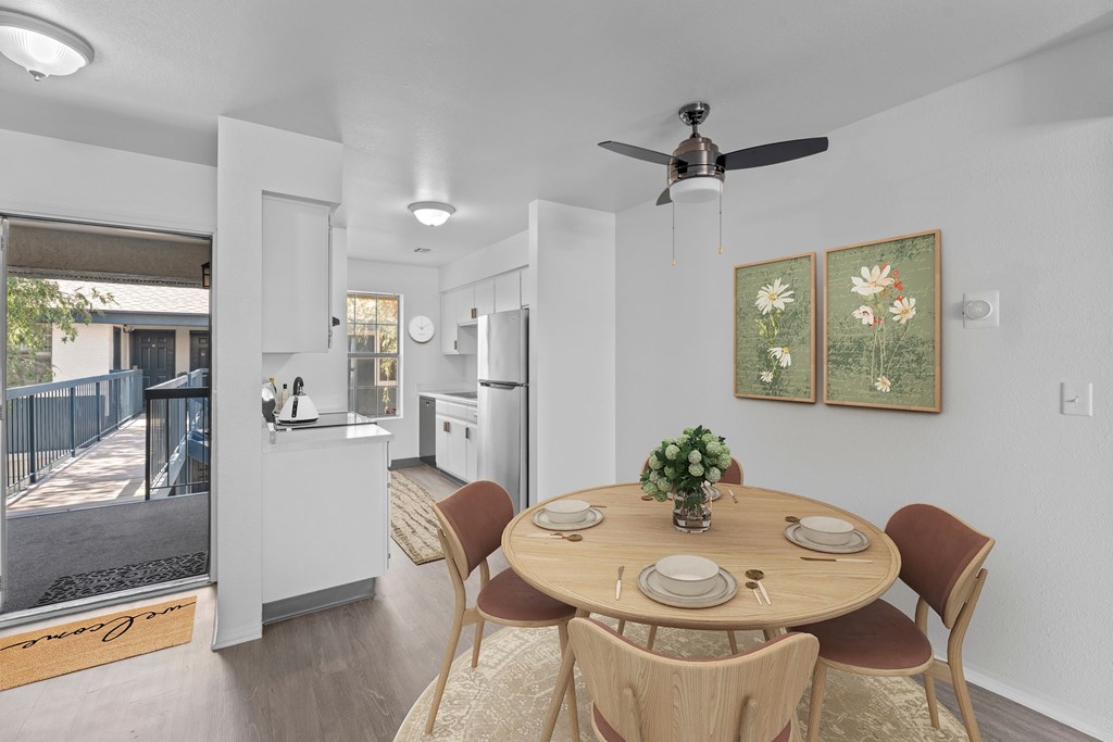 A dining room with a round table and chairs.
