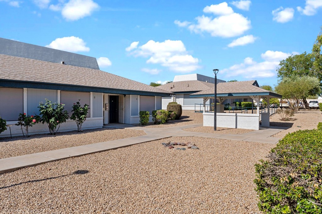 A building with a gravel driveway in front.