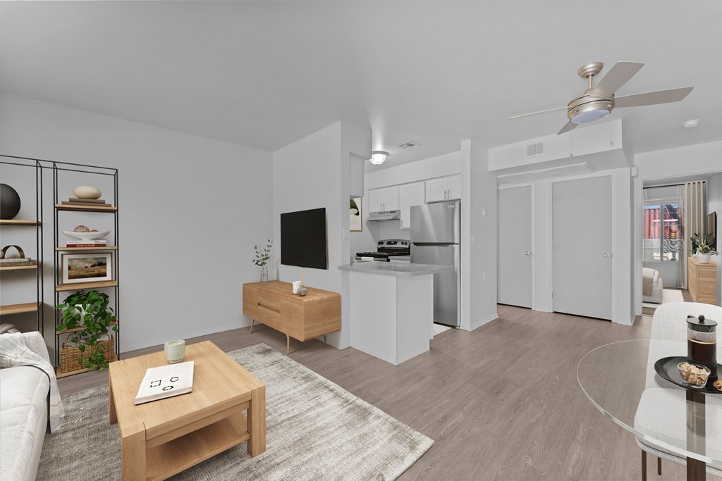 A modern living room with a white sofa, a wooden coffee table, and a ceiling fan.