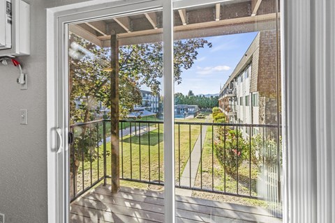 a balcony with a view of a yard and a building