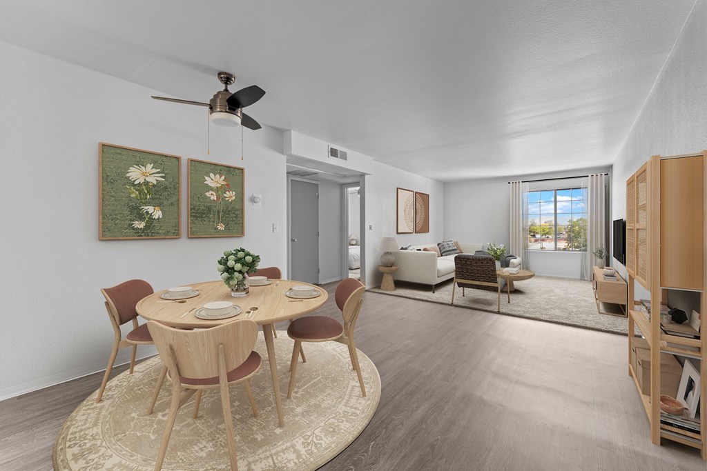 A dining room with a round table and chairs.