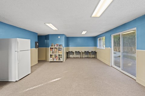 a room with a library and a table with chairs