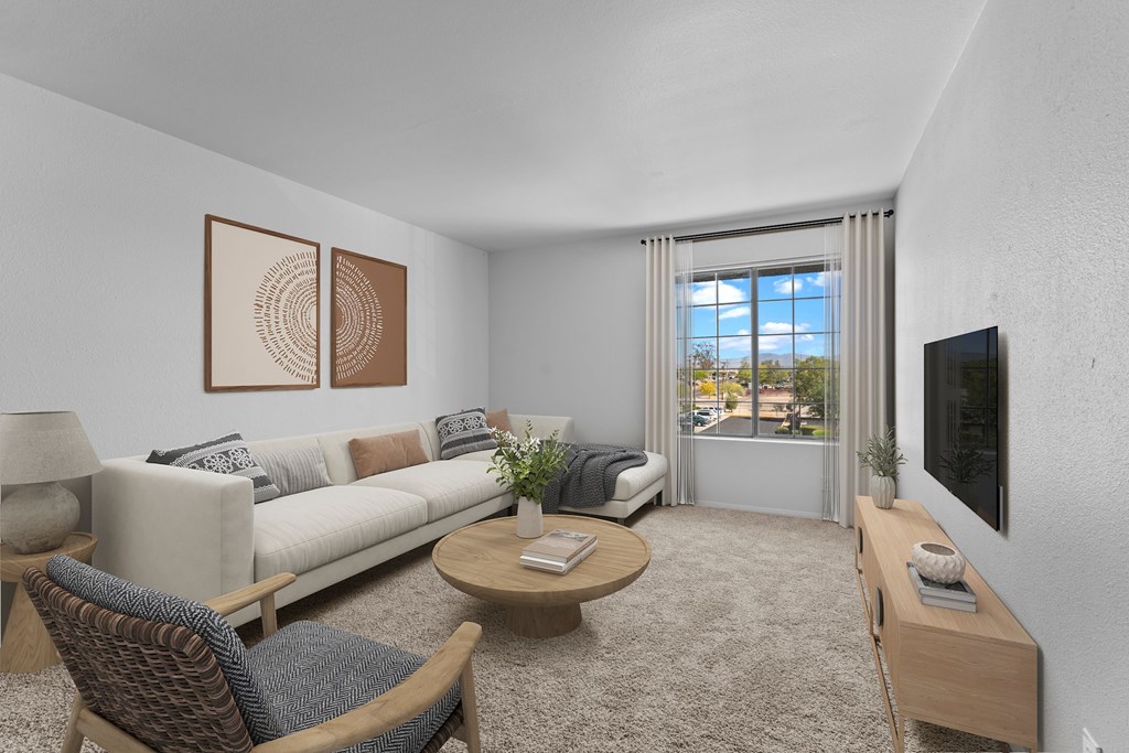 A living room with a couch, chairs, and a coffee table.