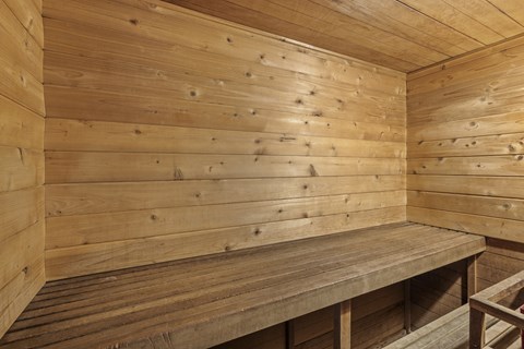 a wooden sauna with wooden walls and a wooden bench