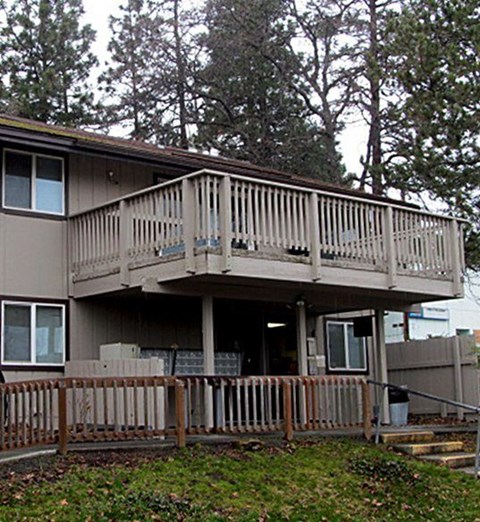 A house with a deck and a fence.