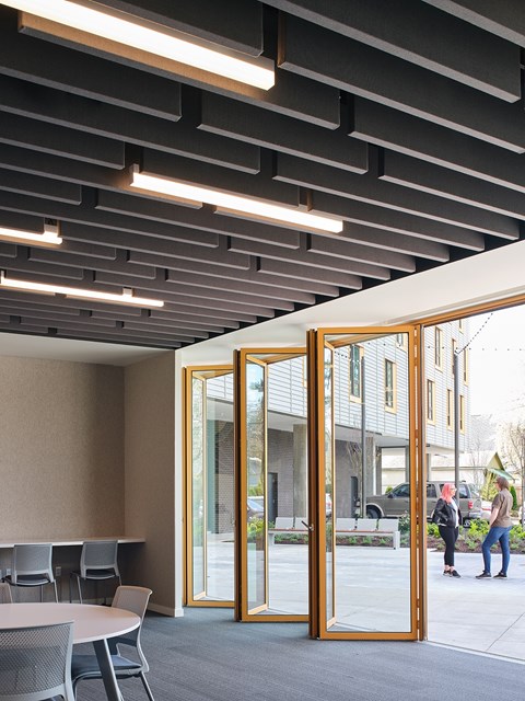 A conference room with a table and chairs and a glass door leading outside.