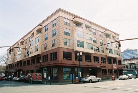 A red building with a green traffic light in front of it.