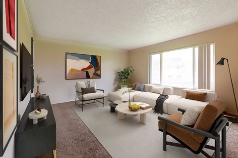A living room with a brown rug and a painting on the wall.