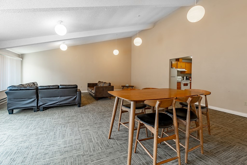 A room with a table and chairs and a couch.