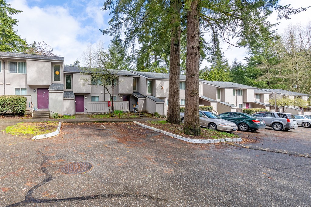 A parking lot in front of apartment buildings.