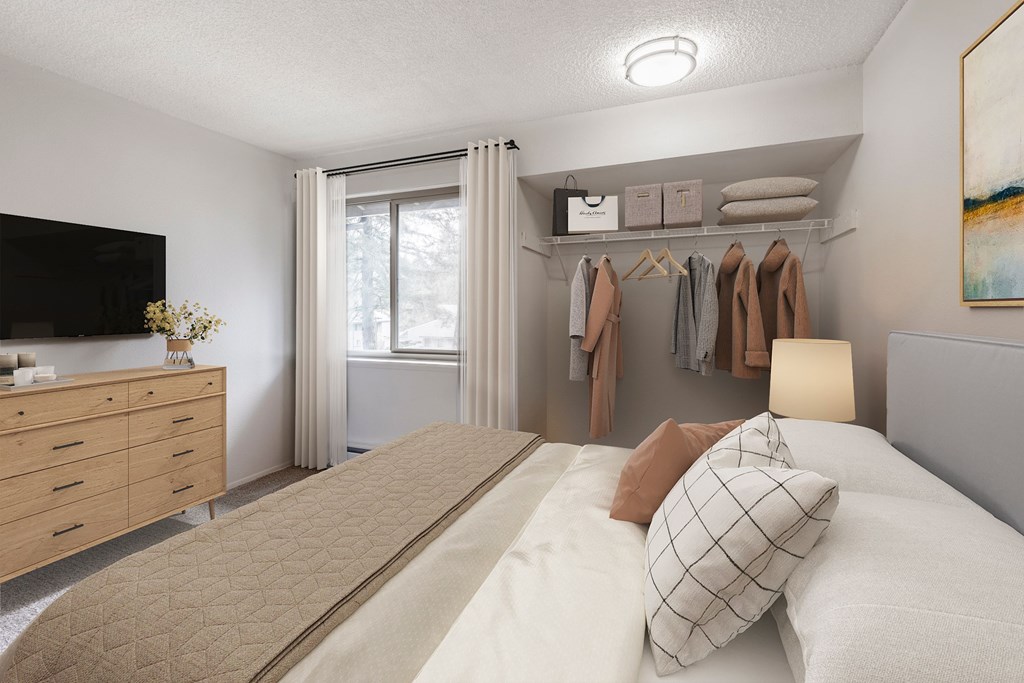 A bedroom with a bed, dresser, and a painting on the wall.