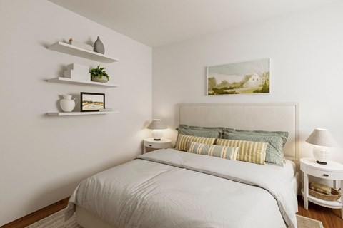 A white bedroom with a large bed and a painting on the wall.