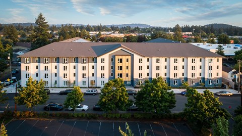 A large building with a parking lot in front of it.