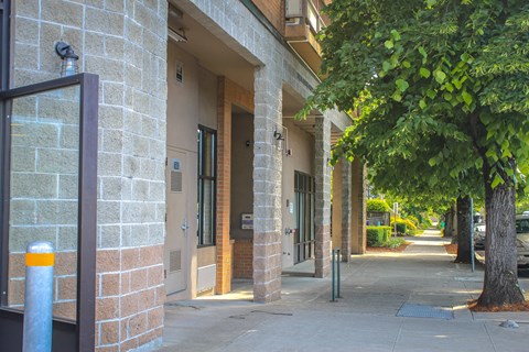 A building with a yellow bollard in front of it.