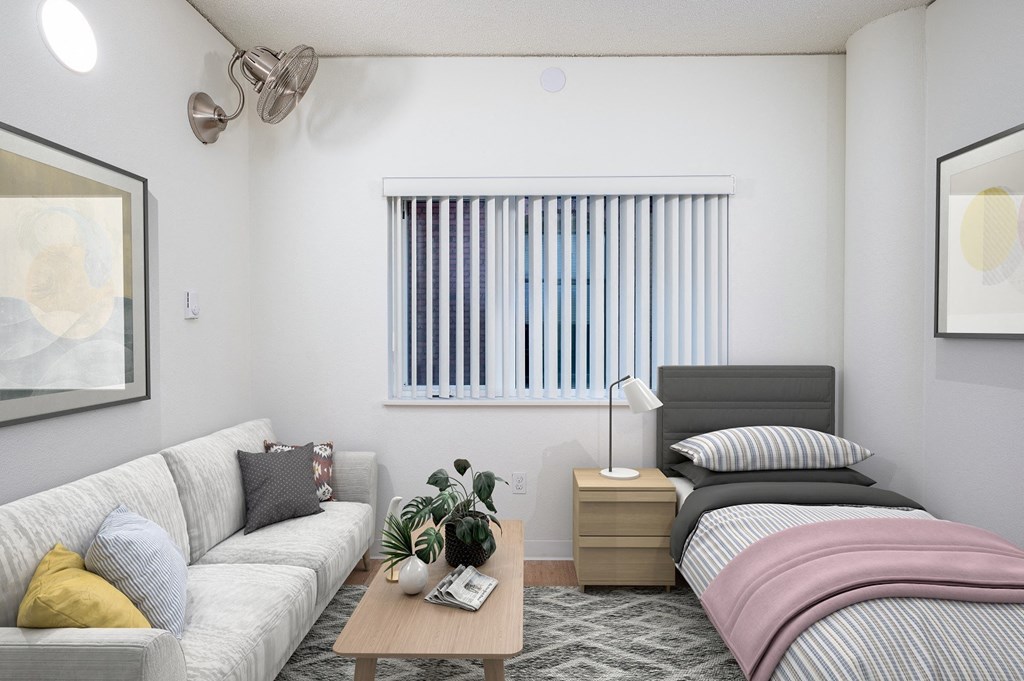 a bedroom with a bed and couch