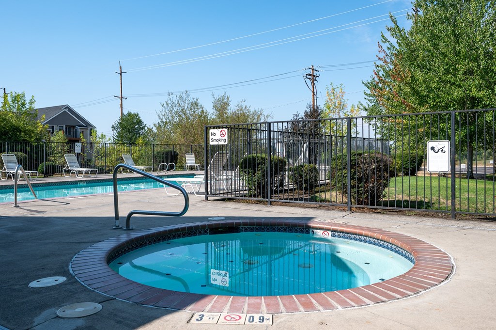 A pool with a sign that says "No Diving" is surrounded by a fence.