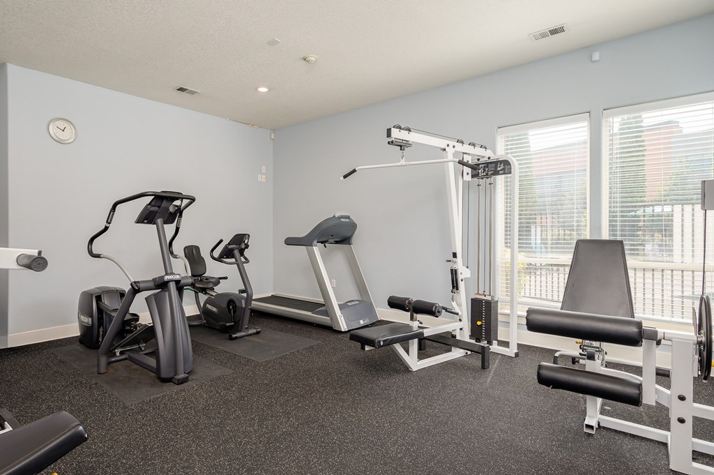 A well equipped gym with a variety of exercise equipment.