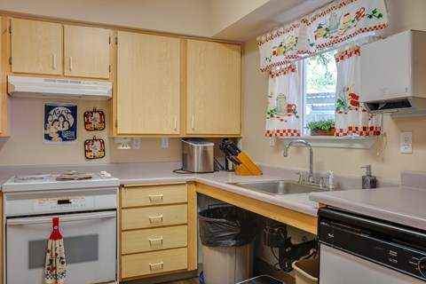 A kitchen with wooden cabinets and a white oven.