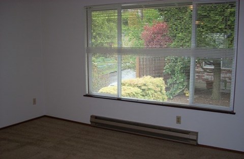 A room with a window covered in blinds.