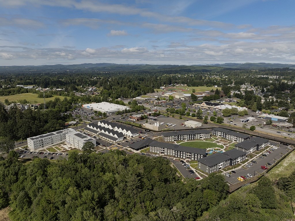 An aerial view of a large building complex surrounded by trees.