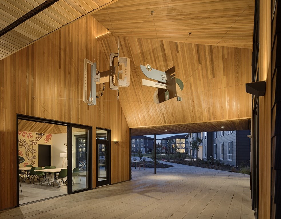 A wooden room with a glass door and a table and chairs outside.