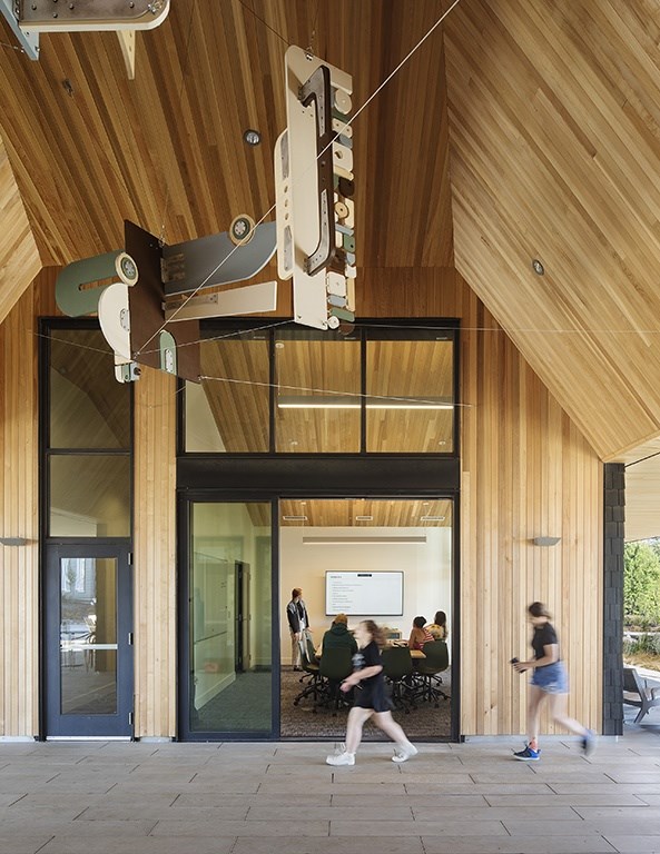 A modern building with people walking in front.