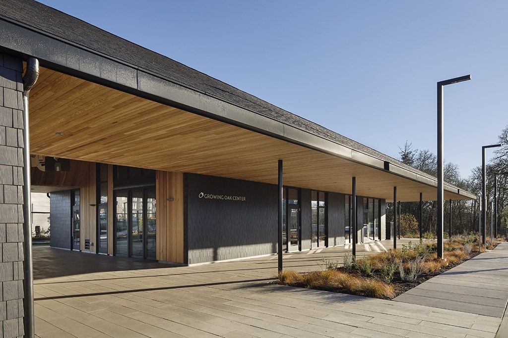 A modern building with a wooden facade and a covered walkway.
