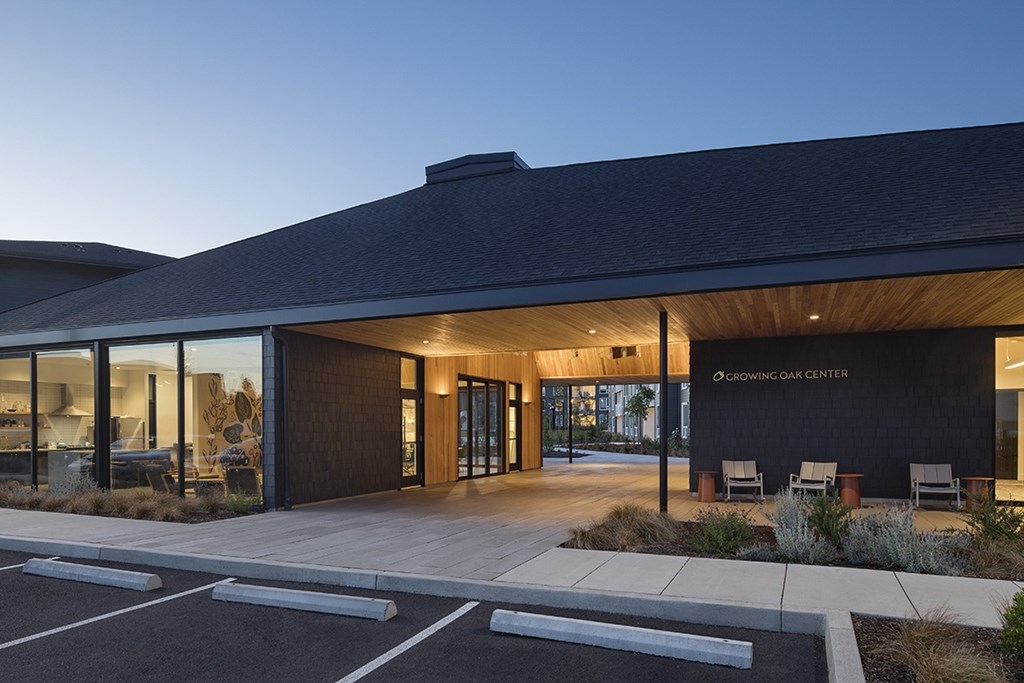A modern building with a dark roof and a sign that reads