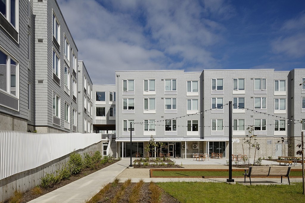 A modern building with a courtyard in front.