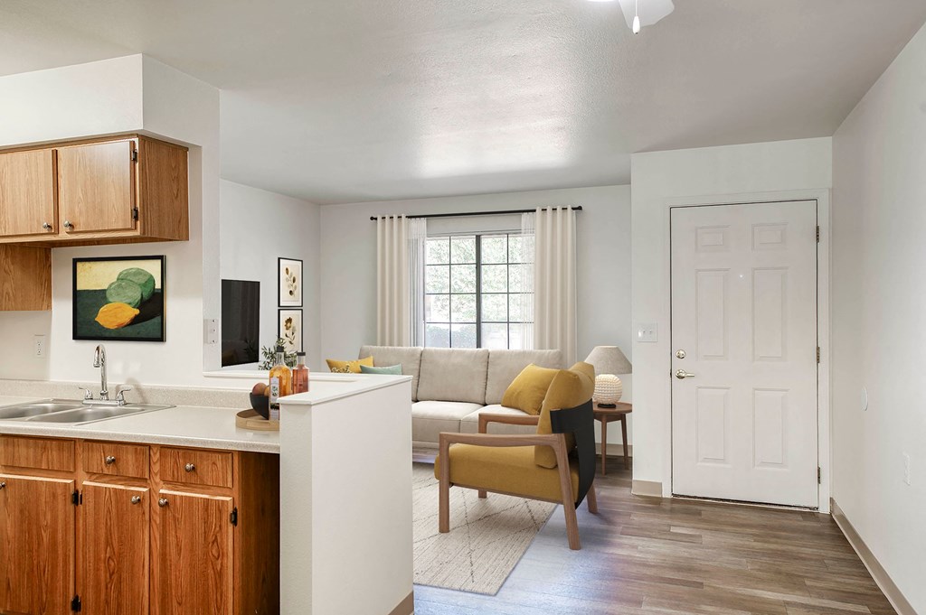 a living room and kitchen with a couch and a table