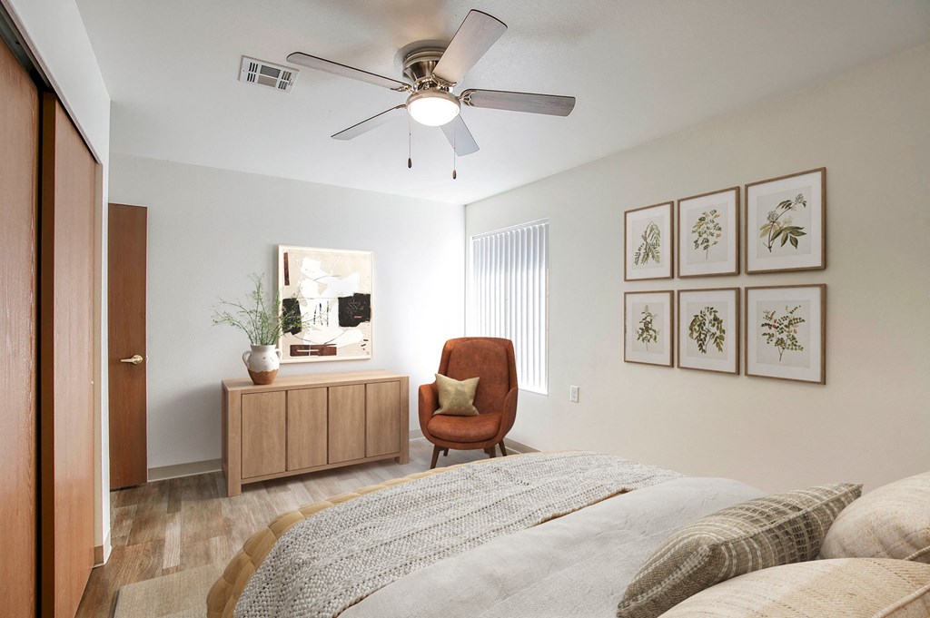 a bedroom with a bed and a ceiling fan