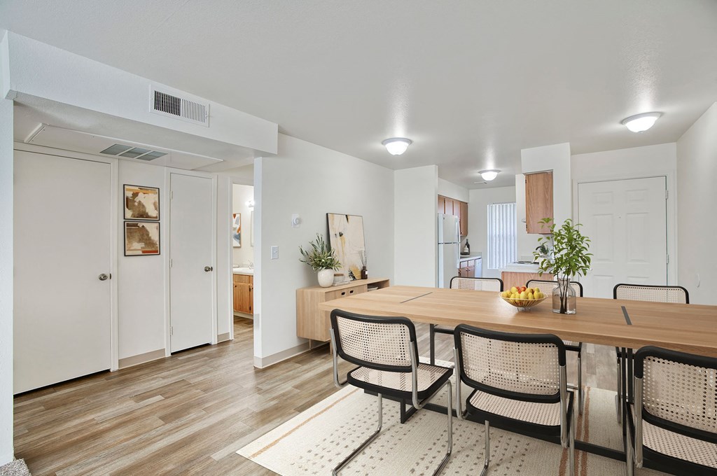 a dining room with a wooden table and chairs