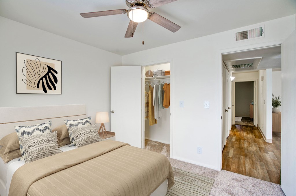 a bedroom with a large bed and a ceiling fan