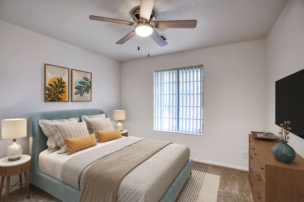 a bedroom with a bed and a ceiling fan