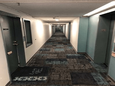 a long hallway with doors in a building