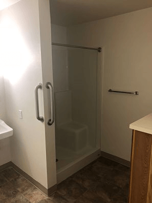 a small bathroom with a shower and a sink