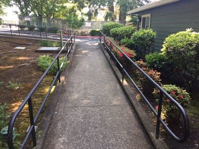 a walkway in a garden with a house