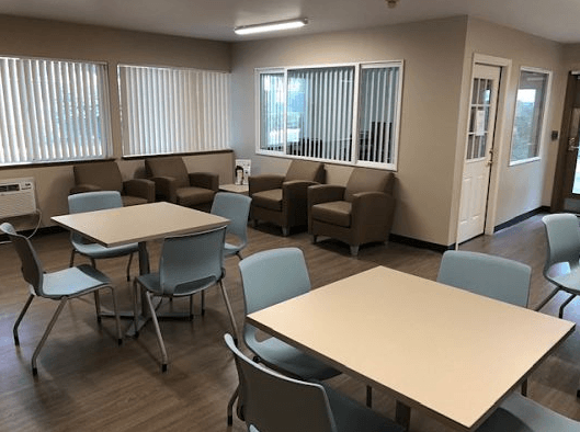 a dining room with tables and chairs and a seating area
